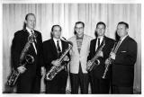 Musicians holding saxophones in a group photo